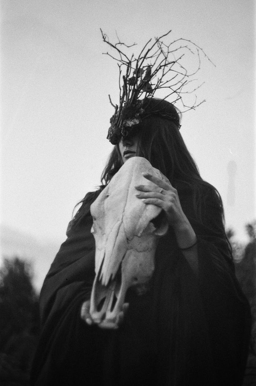 portrait of witch holding animal skull