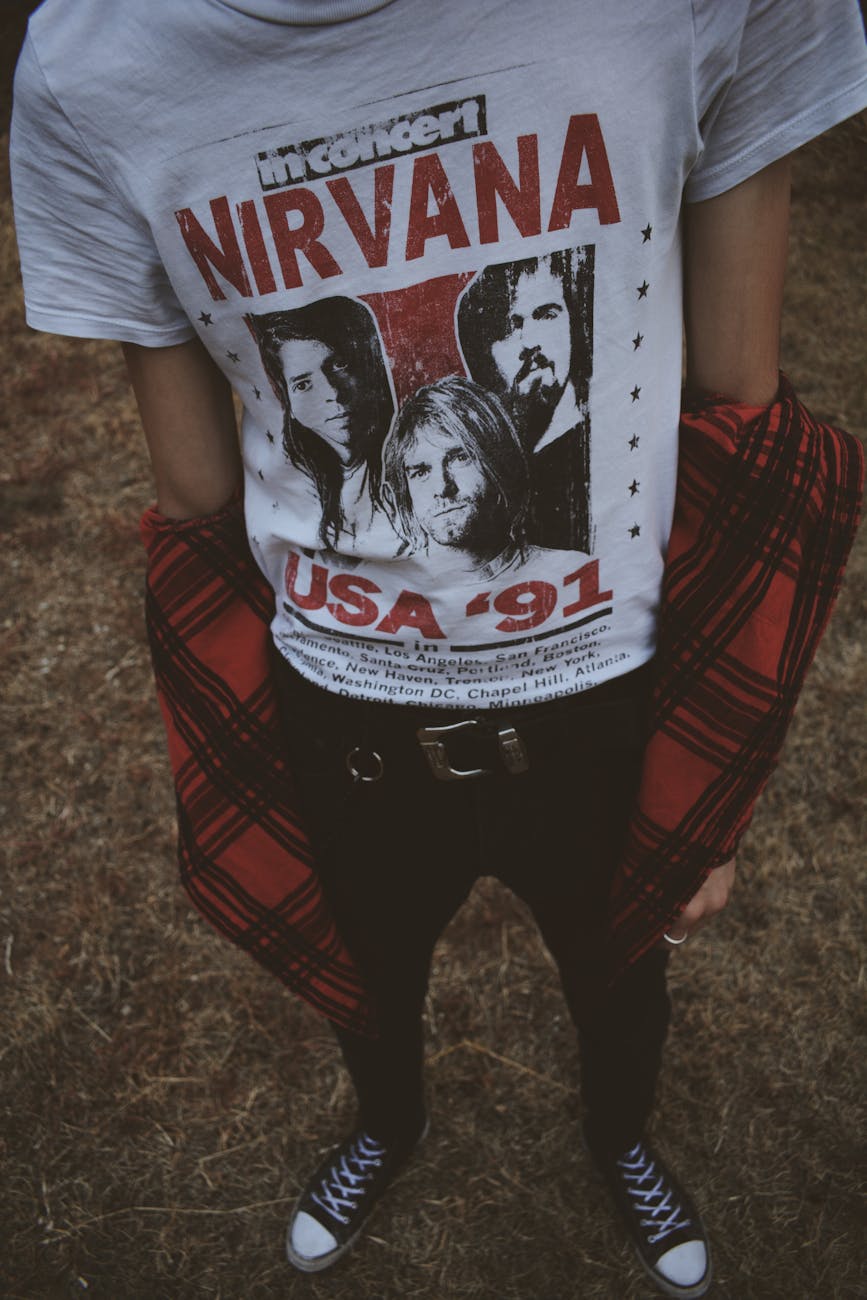 person wearing white and red nirvana top