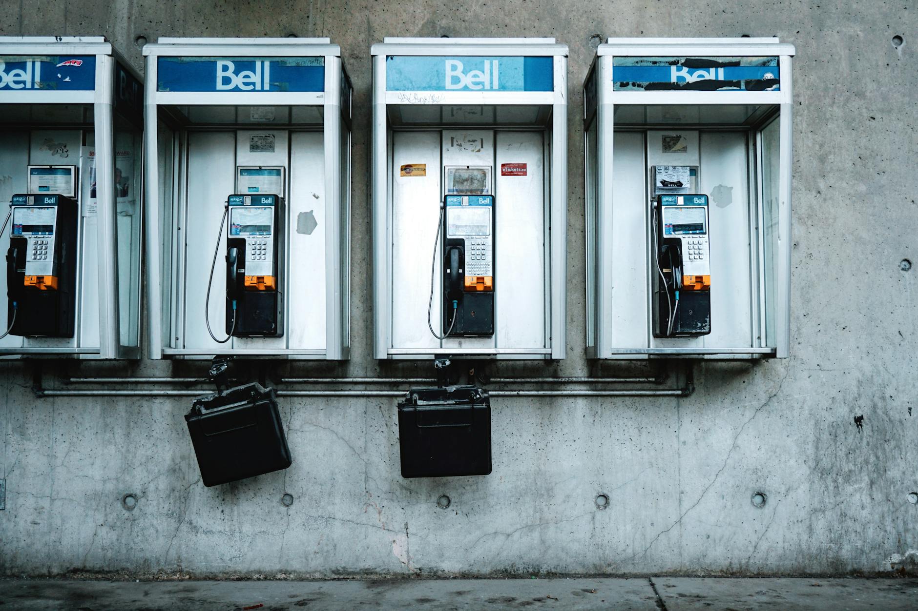 four black and white telephones