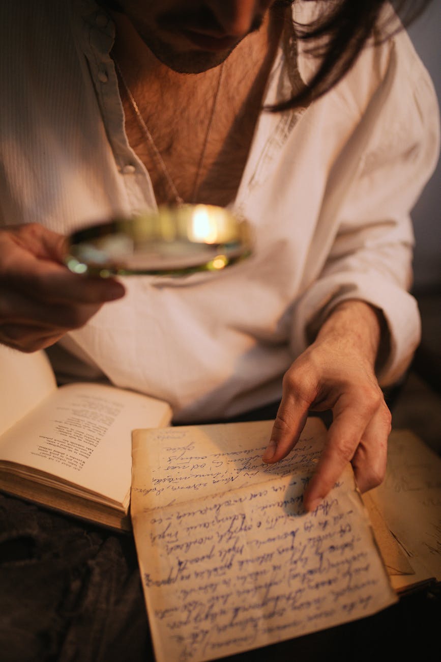 a person holding a magnifying glass and a paper