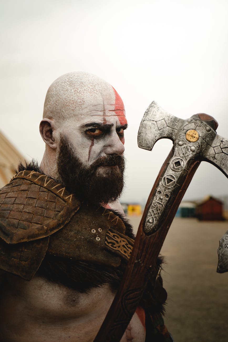 viking warrior with tribal face paint holding battle axe