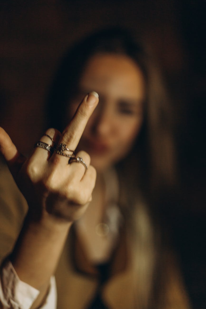 woman showing a middle finger - Photo by Fidan Mammadli on Pexels.com
