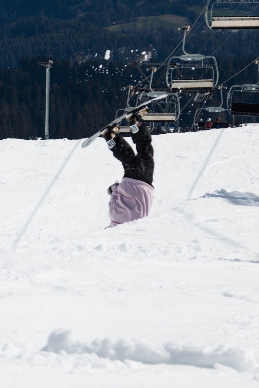 snowboarder tumbles in laax snowpark